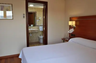 Cama o camas de una habitación en Hotel Mari Carmen