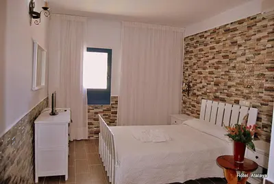 Cama o camas de una habitación en Hotel Atalaya