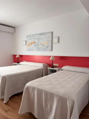 Cama o camas de una habitación en Hostal Las Dunas