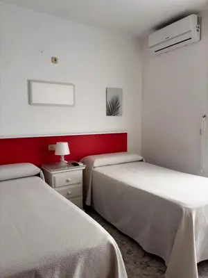 Cama o camas de una habitación en Hostal Las Dunas