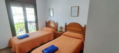 Cama o camas de una habitación en Apartamentos Turísticos Edificio del Pino