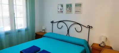 Cama o camas de una habitación en Apartamentos Turísticos Edificio del Pino