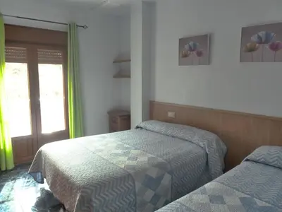 Cama o camas de una habitación en Apartamentos Casa FERMINA - A 2 horas de las pistas de esquí