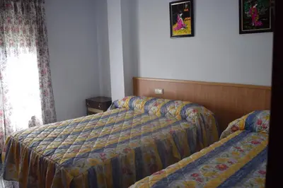 Cama o camas de una habitación en Apartamentos Casa FERMINA - A 2 horas de las pistas de esquí