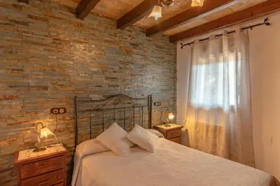 Cama o camas de una habitación en Alojamientos Rurales Los Macabes