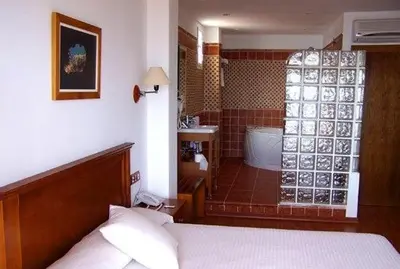 Cama o camas de una habitación en Hotel Donde Caparrós