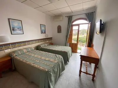 Cama o camas de una habitación en Hotel Simón