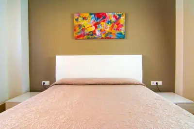 Cama o camas de una habitación en Apartamentos 16:9 Suites Almería