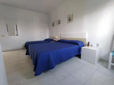 Cama o camas de una habitación en Hotel Rancho del Mar