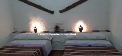 Cama o camas de una habitación en Cuevas Lourdes