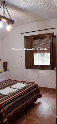 Cama o camas de una habitación en Cuevas Lourdes