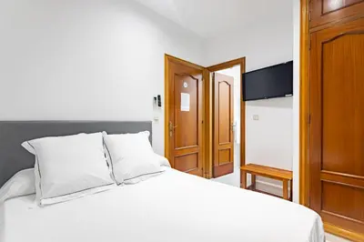 Cama o camas de una habitación en Hostal La Costa