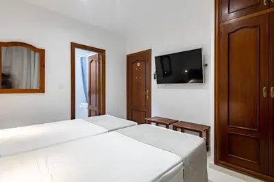 Cama o camas de una habitación en Hostal La Costa