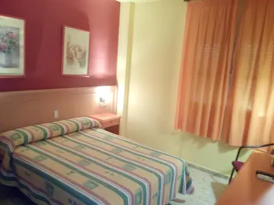 Cama o camas de una habitación en Hostal Carlos III