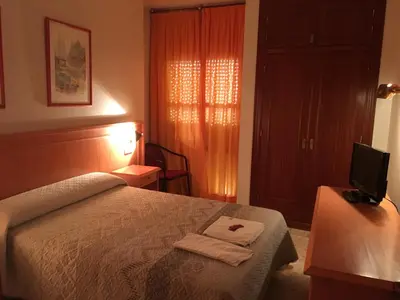 Cama o camas de una habitación en Hostal Carlos III