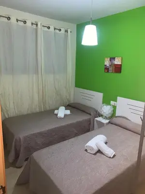 Cama o camas de una habitación en Apartamentos 16:9 Playa Suites