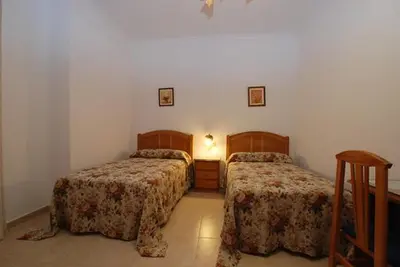 Cama o camas de una habitación en Hostal el Puente