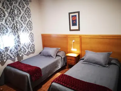 Cama o camas de una habitación en Hostal Los Hermanos