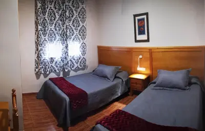 Cama o camas de una habitación en Hostal Los Hermanos