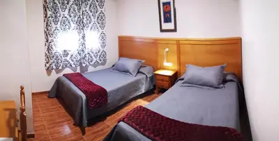 Cama o camas de una habitación en Hostal Los Hermanos