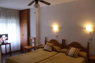 Cama o camas de una habitación en Pension Americano