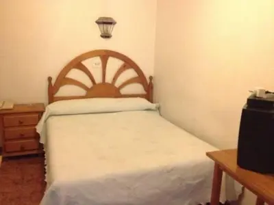 Cama o camas de una habitación en Pension Americano