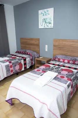 Cama o camas de una habitación en Pension Cuatro Vientos