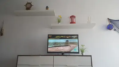 Una televisión o centro de entretenimiento en Apartamento Playa Salinas Roquetas de Mar