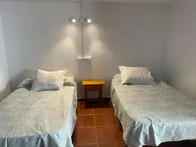 Cama o camas de una habitación en Palacete Magistral Domínguez habitaciones