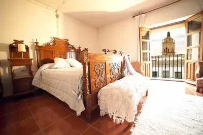 Cama o camas de una habitación en Palacete Magistral Domínguez habitaciones