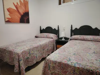Cama o camas de una habitación en APARTAMENTO JAZMINERO