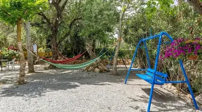 Zona de juegos infantil en Spacious villa with mountain view and pool in Baza