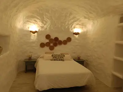 Cama o camas de una habitación en Cueva OTTO Familiar Privada