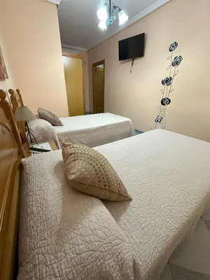 Cama o camas de una habitación en Hostal Avenida