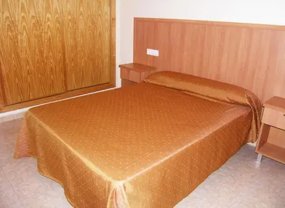 Cama o camas de una habitación en Apartamentos Cibeles