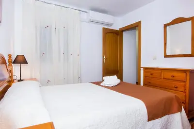 Cama o camas de una habitación en Apartamentos Sol Andaluz
