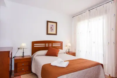 Cama o camas de una habitación en Apartamentos Sol Andaluz