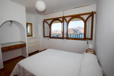 Cama o camas de una habitación en CasaMarga San José Precioso apartamento con piscina y vistas al mar