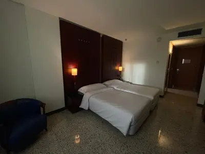 Cama o camas de una habitación en Hotel Amaltea by Executive Sport