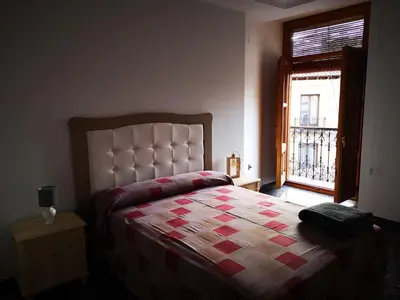 Cama o camas de una habitación en Casa La Lonja de Guadix