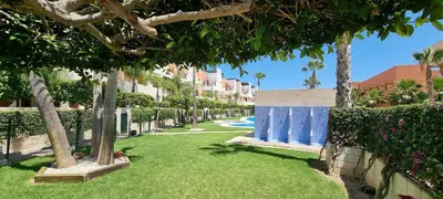 Jardín al aire libre en Homes of Spain, Apartamentos Paraíso Vera Playa, Ed Nuku Hiva, Bajo W con jardín y piscina privada a pie de playa, WIFI