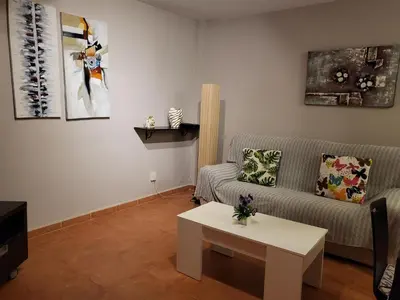 Zona de estar de Casa baja preciosa con jardín privado en primera línea naturista!