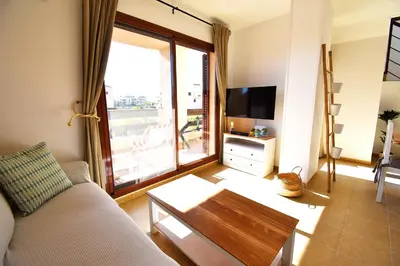 Una televisión o centro de entretenimiento en Marinas Sunset - Tu Dúplex con Solarium Privado!
