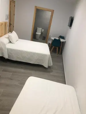 Cama o camas de una habitación en Alojamientos Tía María