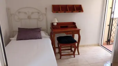 Cama o camas de una habitación en Habitaciones Jacaranda