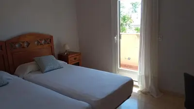Cama o camas de una habitación en Habitaciones Jacaranda