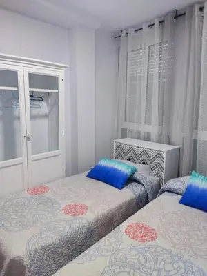 Cama o camas de una habitación en Apartamentos a 300 metros playa