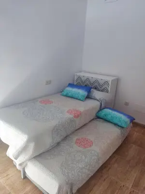 Cama o camas de una habitación en Apartamentos a 300 metros playa