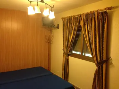 Cama o camas de una habitación en Hostal Delfin Verde