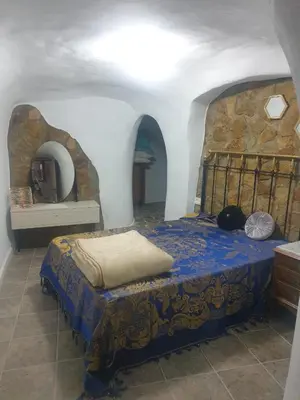 Cama o camas de una habitación en Cuevas Roj0 Membrives Posadas 1